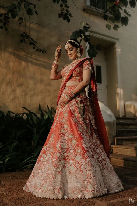 Photo of anamika khanna red and gold modern bridal lehenga