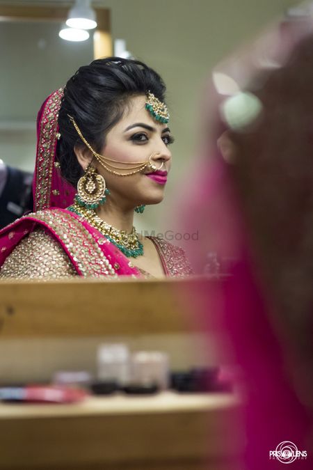 Photo of bride looking in mirror