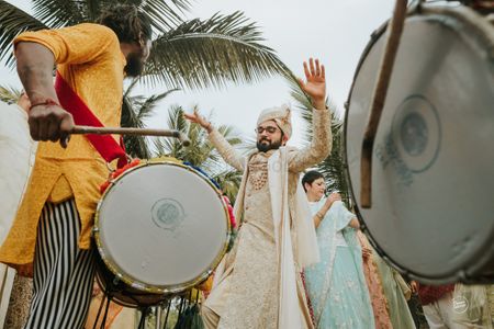 Photo of groom dancing with dhol at baraat