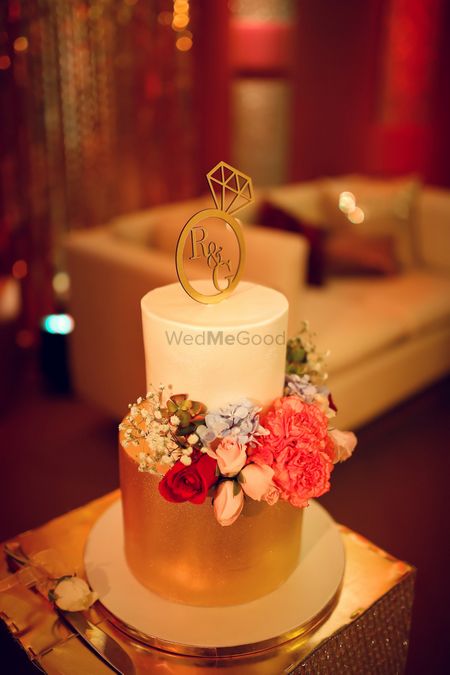 2 tier floral cake with engagement ring cake topper