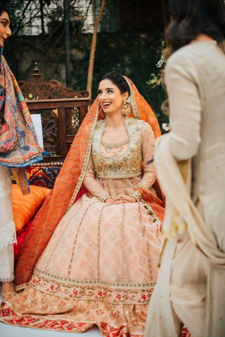 Photo of A bride dressed in a peach Anarkali suit.