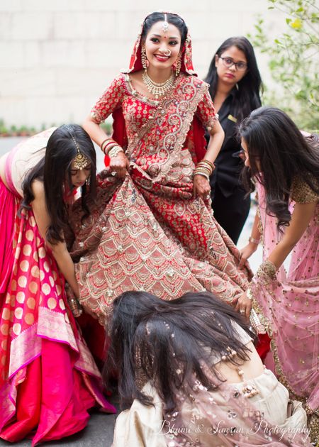A bride in a goofy moment with her bridesmaids 