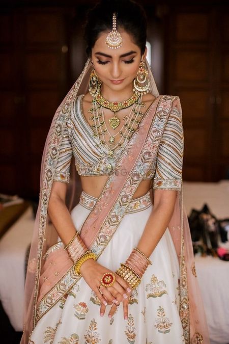 Simple bridal look with ivory lehenga and subtle makeup