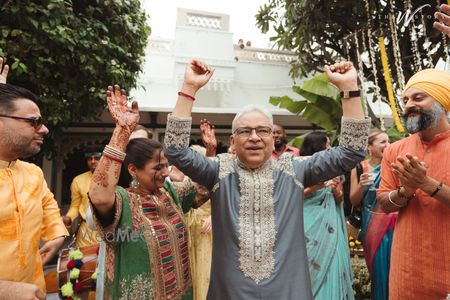 Cute candid moment where the father and mother of the bride dance their heart out at the mehendi