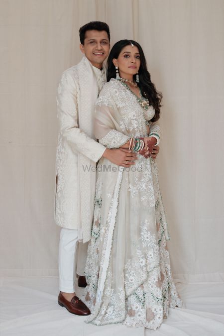 Photo of Beautiful all-ivory colour co-ordinated couple, posing just before their wedding day