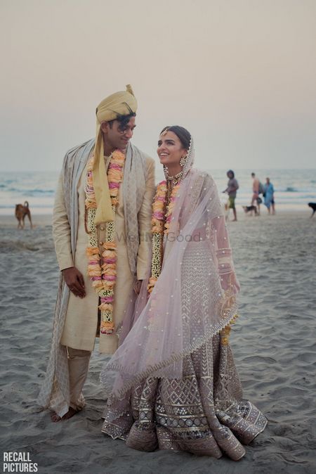 Beach wedding couple shot with lilac lehenga 