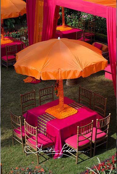 Photo of orange umbrella with genda flowers