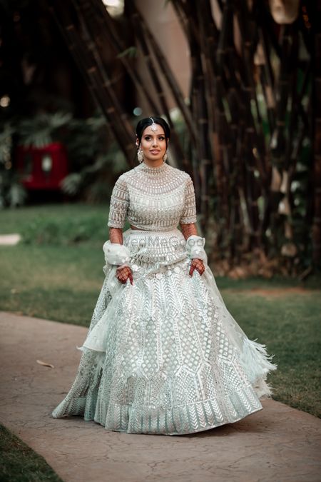 Bride wearing a silver lehenga on engagement.