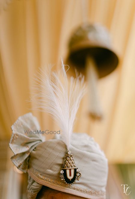 A Balaji Tirupati design kalgi with diamonds for the groom on his safa