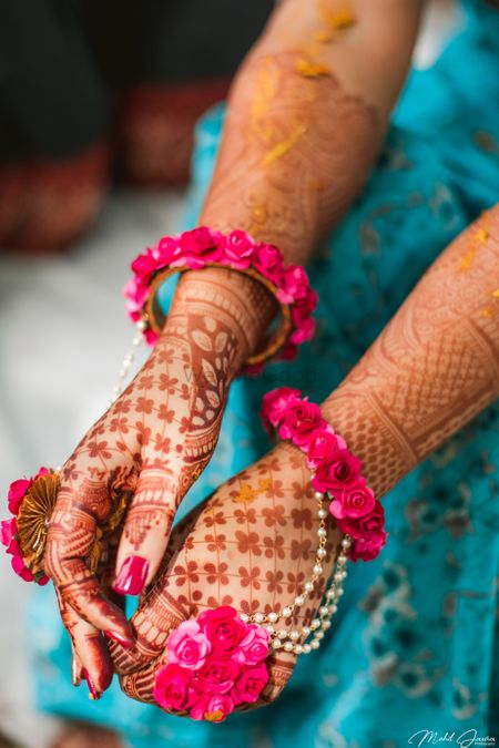 Mehendi hands with pink floral haathphool 