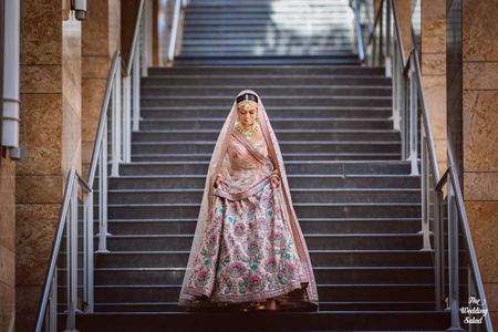 Photo of bridal portrait with the bride in a pastel pink sabyasachi lehenga