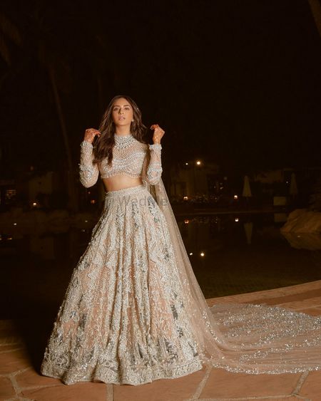 Photo of Stunning nude on white lehenga with a train style dupatta and all diamond jewellery