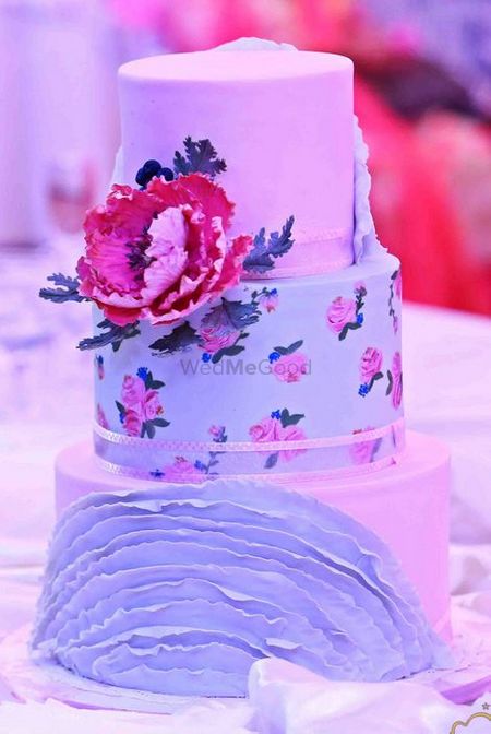 Photo of elegant whimsical cake with floral print tier