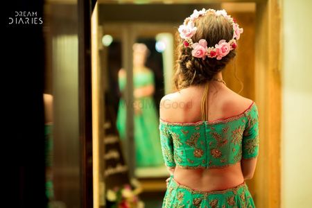Mehendi hairstyle with floral wreath