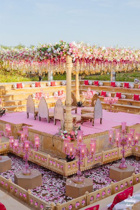 Photo of light pink and gold theme grand mandap with florals