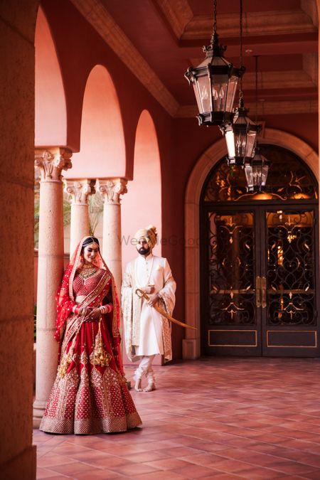 Editorial style royal shoot with bride in red sabyasachi lehenga
