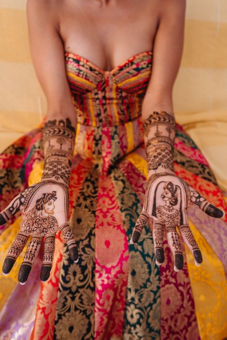 Photo of mehendi design with mehendi outfit of bride