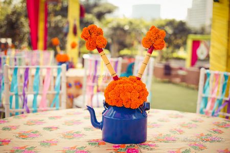 Photo of Royal blue kettle with flowers centerpiece
