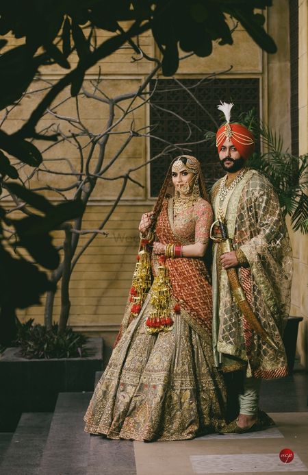 A sikh bride and groom in coordinated vintage outfits
