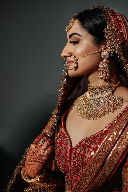 Bride wearing a red lehenga with a statement choker set