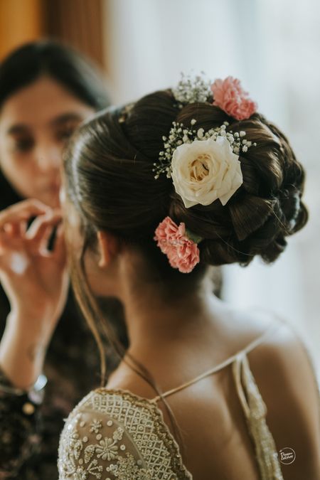 bridal braided bun with white and pink flowers