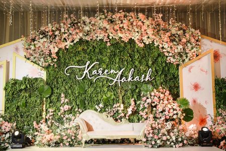 Beautiful stage decor for reception with a stunning personalised backdrop. 