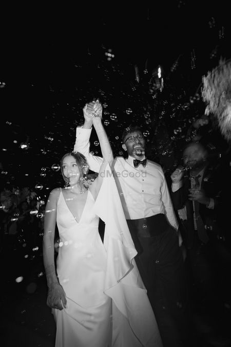Fun couple portrait in monochrome with bride in a white gown