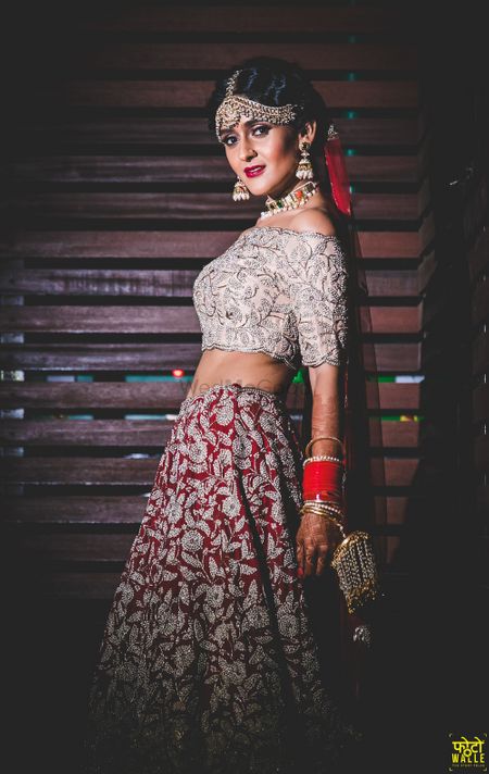 Modern bridal lehenga in silver and red with off shoulder blouse 