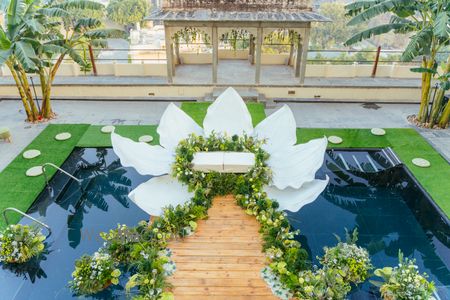 Photo of Dreamy floral and white stage floating with a lotus style seating