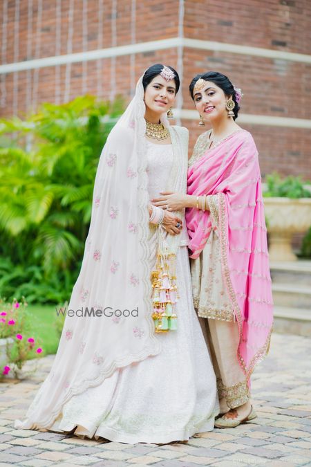 pastel pink sikh bride with her sister before the wedding