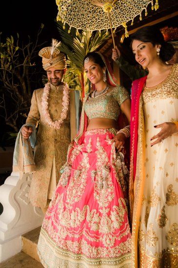 Bride wearing a pastel pink lehenga with a yellow dupatta and emerald  jewellery. | Pink bridal lehenga, Indian bride outfits, Indian wedding  dress designers