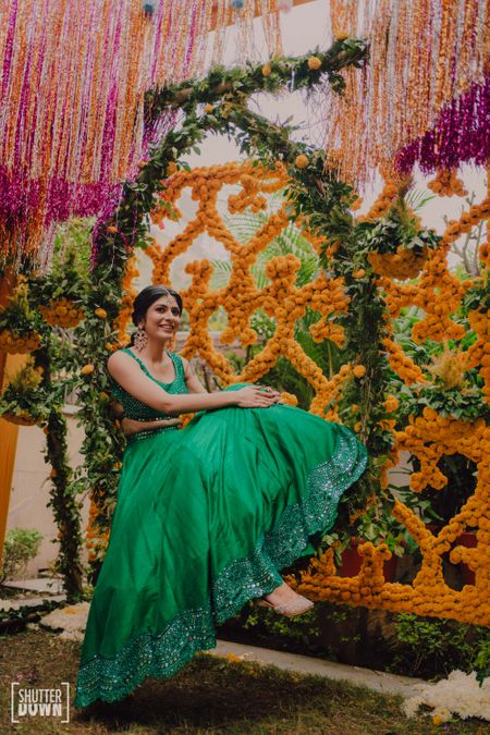 Bride in pretty green outfit for the mehendi 