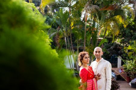 A couple portrait with the bride in red and the groom in white 
