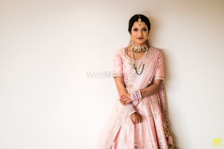 Bride in a light pink lehenga