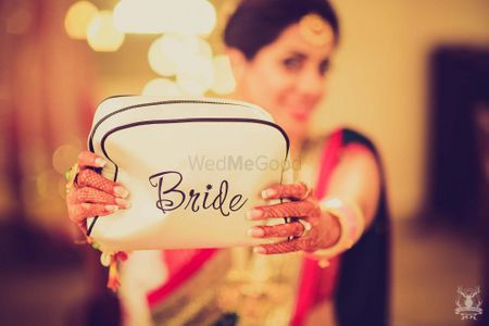 Photo of Bride getting ready with customised makeup bag