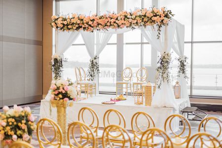 Photo of indoor white and gold theme minimal mandap