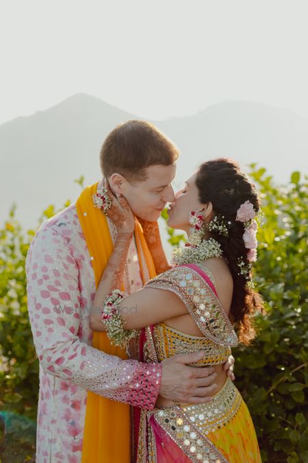 Lovely candid capture of the bride and groom kissing with the bride in baby breath floral jewellery