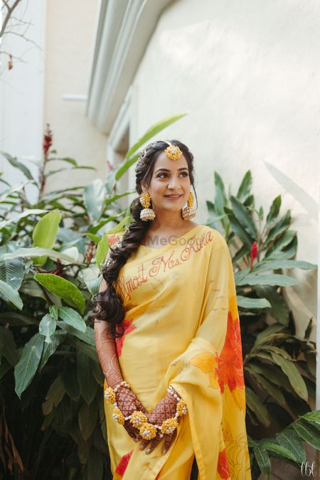haldi bridal look with personalised saree and side braid