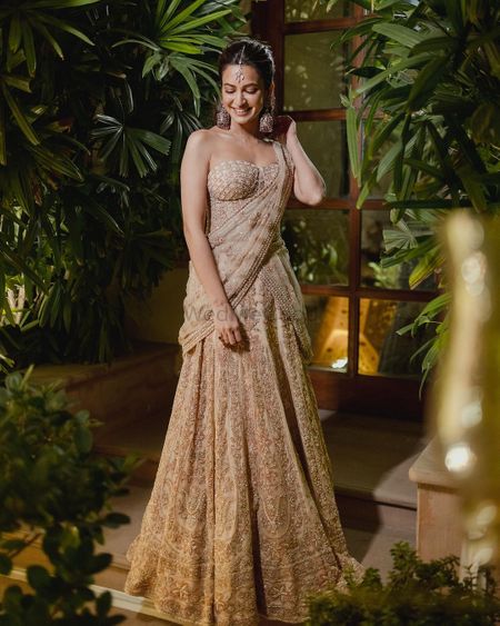 Stunning gold strapless gown saree with statement jhumka earrings 