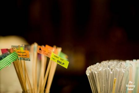 Photo of drink stirrers with sayings tagged on them