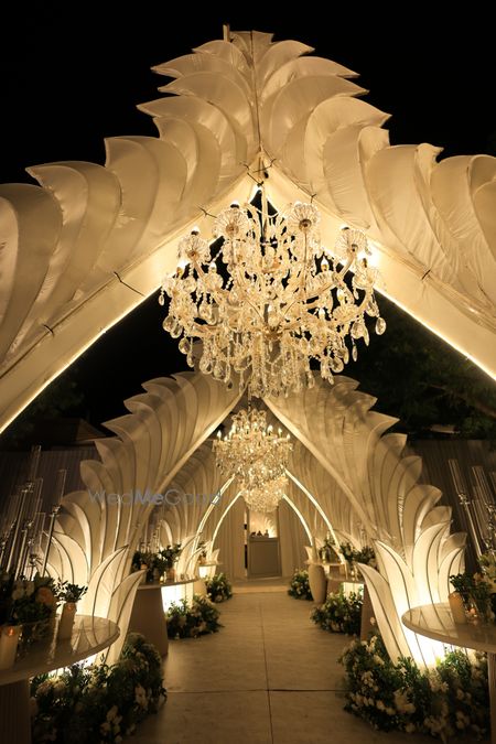 Gorgeous wedding decor entrance in all white and crystal chandeliers