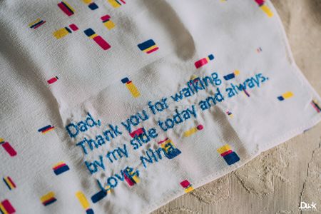 Photo of Embroidered message from bride to father on napkin