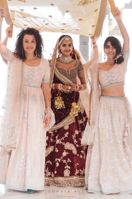 Photo of Unique bridal entry with bridesmaids holding phoolon ka chadar