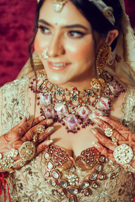 Bride wearing an enameled bridal choker with a rani haar.