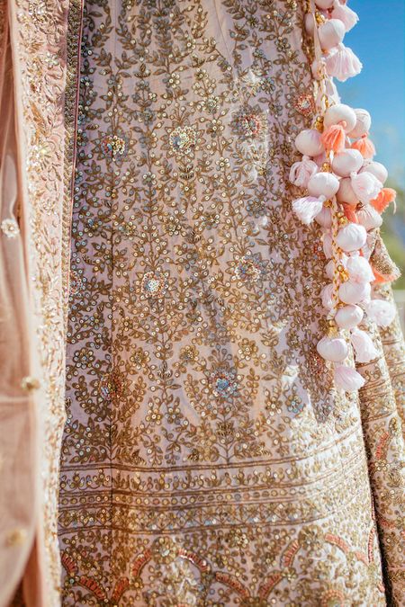 Pretty light pink latkans with gold and pastel pink lehenga for wedding 