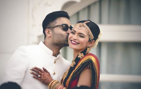 South Indian wedding with groom kissing bride