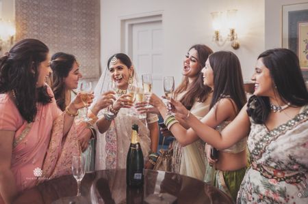 bride raising a toast with her squad