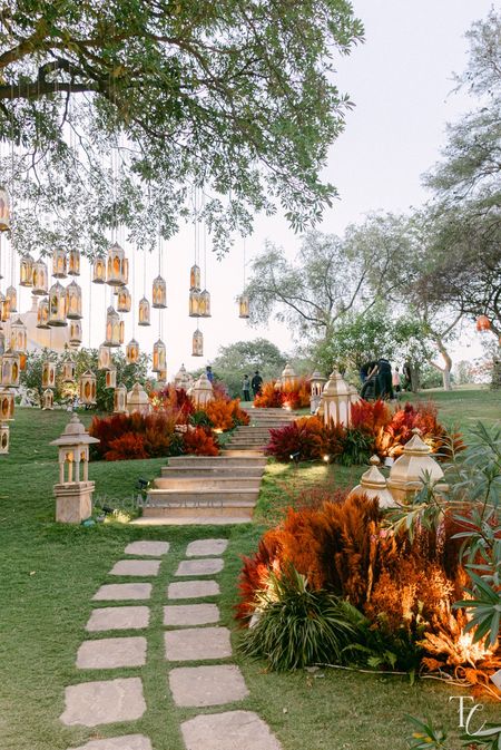 Gorgeous entrance decor with morrocan hanging lamps and dry orange floral decor for a haldi