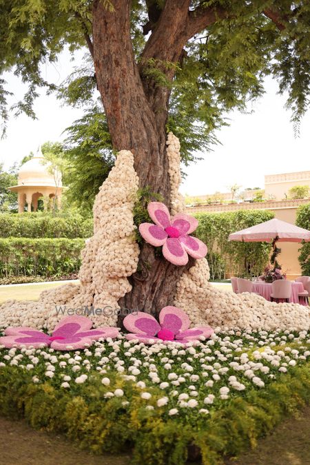 Statement floral decor on a tree with white and pink florals 