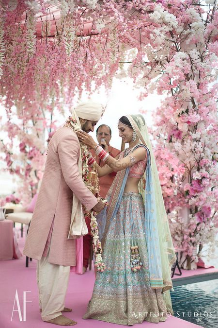 Offbeat bride in light pink and blue lehenga matching the decor